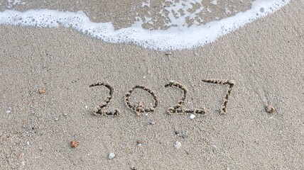 close up of year 2027 numbers written on the sand