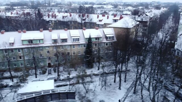 chilly morning urban landscape picture, snowy rooftops and dormant trees depict winter atmosphere . Media
