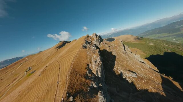 Smooth flight along the mountain range, filmed by FPV drone. Seceda, Italy