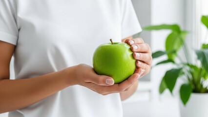 Holding Apple: A person holds a fresh, vibrant green apple. This image is a testament to natural simplicity and wholesome eating, with health and wellness at its core.