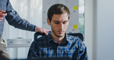 Team adult male engineer collaborate on robotic hand project using AI code solutions machine learning at tech workspace. Artificial intelligence interface, collaboration support prototype development.