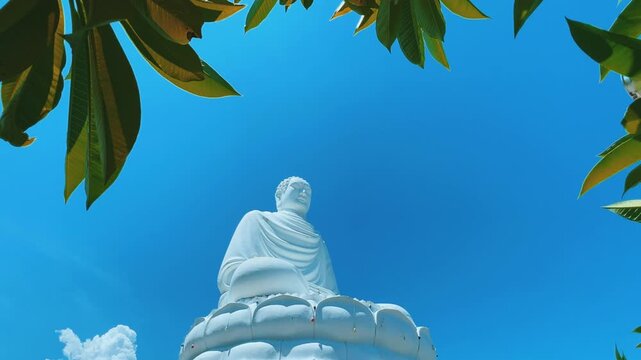Nha Trang, Vietnam - September 18, 2025. Chua Long Son Pagoda with a large white Buddha statue in the vast, clear blue sky. The main Buddhist temple of Kien Giang Province. 4К	
