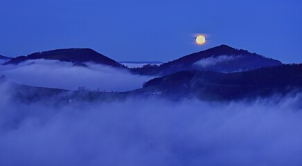 View from the Gisliflue of the Jurassic foothills covered in fog from the left, Asperstrihen, Strihen, in the light of the full moon, Talheim, Canton, Aargau, Switzerland