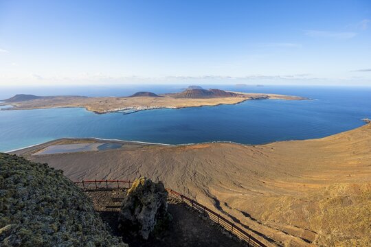 View of La Graciosa island with volcanic craters in the evening light, Mirador del R&iacute;o viewpoint designed by artist C&eacute;sar Manrique, Lanzarote, Canary Islands, Spain