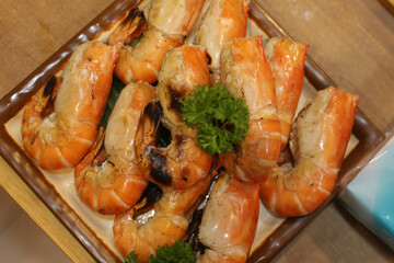 Several grilled prawns on a seafood plate