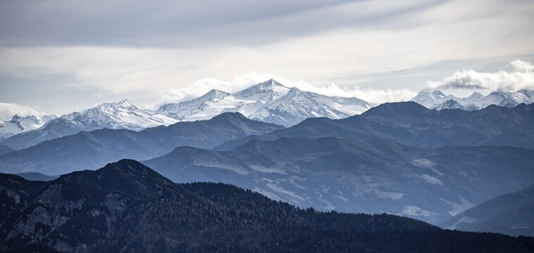 View of the Alpine foothills and the main Alpine ridge with snow-covered peaks, from the Austrian Schinder, Bavarian Alps, Mangfall mountains, Bavaria, Germany