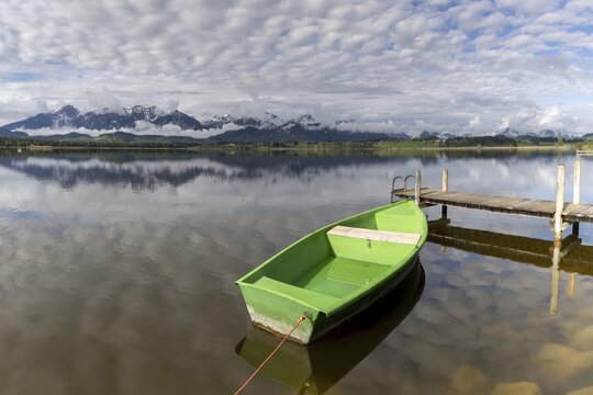 Rowing boat at sunrise, Hopfensee, Hopfen am See, near F&uuml;ssen, Ostallg&auml;u, Allg&auml;u, Bavaria, Germany