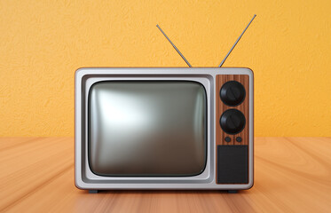 Old vintage TV on the wooden desk on background of orange wall
