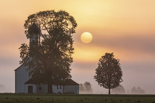 Church at sunrise, fog, sun, backlight, Raisting, Alpine foothills, Bavaria, Germany