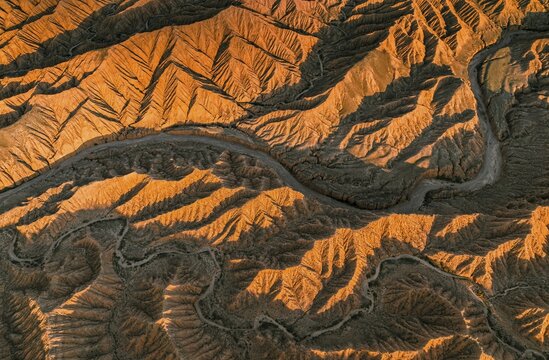Landscape of eroded hills, top-down, badlands at sunset, aerial view, Canyon of the Forgotten Rivers, Issyk Kul, Kyrgyzstan