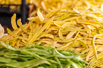 Lots of yellow beans ready for sale at a local farmers' food market. Wax beans, also known as yellow beans or butter beans, are a common type of green bean.