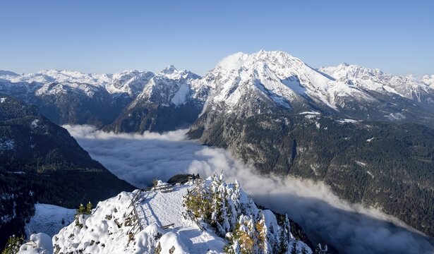 Tourist with camera on a hiking trail, Snow-covered summit of the Jenner with viewing platform in autumn, view of the sea of clouds and Watzmann, Berchtesgaden National Park, Berchtesgaden Alps, Sch&ouml;nau am K&ouml;nigssee, Berchtesgadener Land, Bavaria, Germany