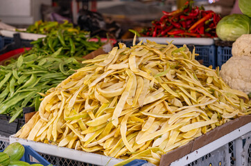 Lots of yellow beans ready for sale at a local farmers' food market. Wax beans, also known as yellow beans or butter beans, are a common type of green bean.
