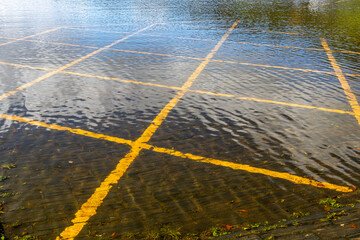 Flooded car park with submerged yellow lines