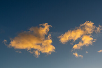 Warm sunset clouds against a blue sky