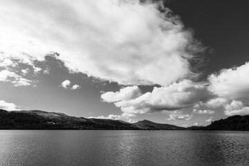 Bala lake with high altitude white fluffy clouds in black and white
