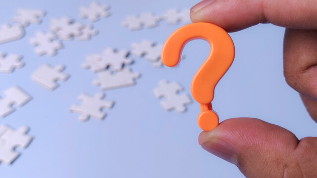 Question Mark Icon and Puzzle Pieces Representing Problem Solving and Finding Solutions to a Mystery
