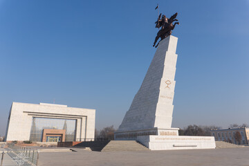 Wide view of Ala-Too Square featuring Manas monument on pedestal right and National History Museum...