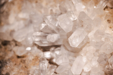 Natural quartz crystal cluster with transparent and milky hexagonal formations on a rocky matrix