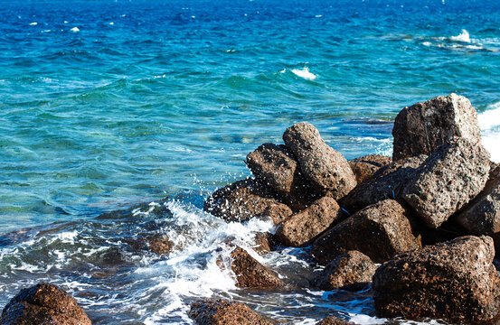 summer shore line rocks stone and blue water breeze close up south vacation place local scene for wallpaper concept - Powered by Adobe