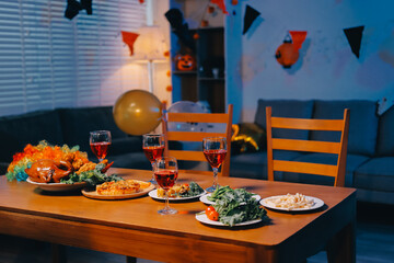 Joyful office Halloween party with coworkers in costumes, celebrating with drinks and laughter, fostering teamwork and festive spirit