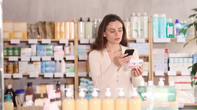 Adult woman buyer scanning qr code for box of paracetamol tablets in pharmacy