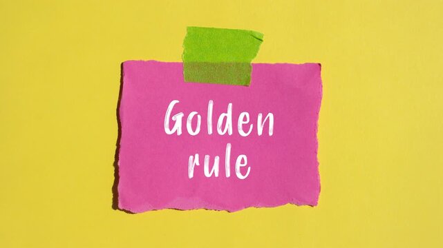 Golden rule message writing on ripped torn paper background