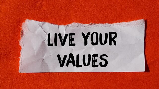 Live your values message writing on ripped torn paper background