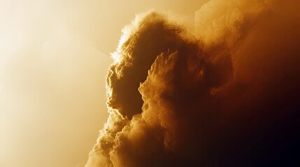 A dramatic view of clouds illuminated by sunlight, creating a warm, golden atmosphere.