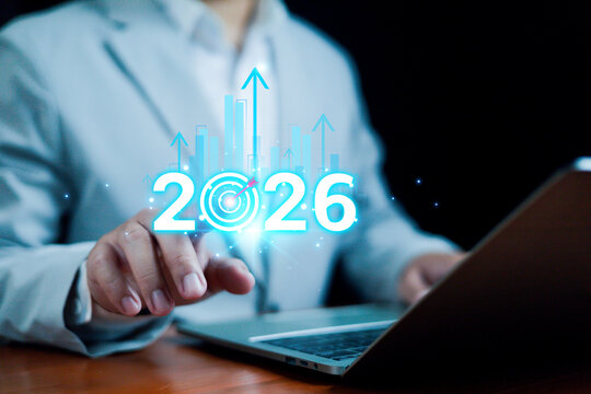 Businessman touching 2026 digital growth graphic with rising bar charts and target icon, symbolizing future strategy, innovation, planning, and business development for upcoming opportunities. - Powered by Adobe