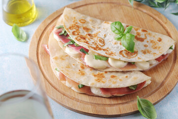 Traditional Italian dish Piadina romagnola - flat bread with mozarella and proscuitto