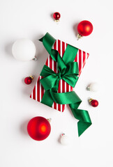 Naklejka premium Merry Christmas and Happy Holidays greeting card, frame, border, banner. New Year. Red green Christmas decoration, ornaments and gifts, presents on white background. Xmas holiday festive theme.