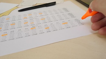 Managing home budget with structured financial notes. Expense categories and income details in printed document. Helps control costs and track financial progress efficiently