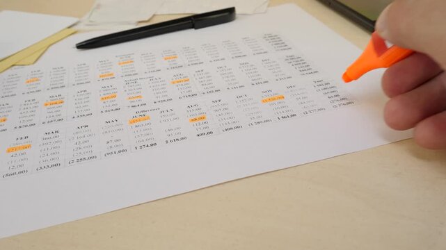 Managing home budget with structured financial notes. Expense categories and income details in printed document. Helps control costs and track financial progress efficiently