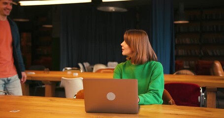 Young successful students collaborating on university project in library giving high five - Powered by Adobe