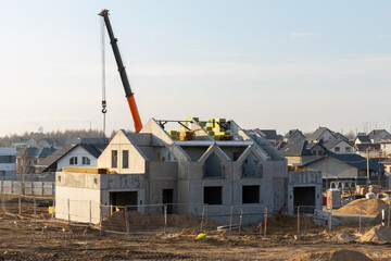 A new concrete two-story house is under construction in a suburban residential development