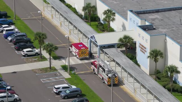 School medical emergency prompts arrival of fire and EMS crews at main entrance.