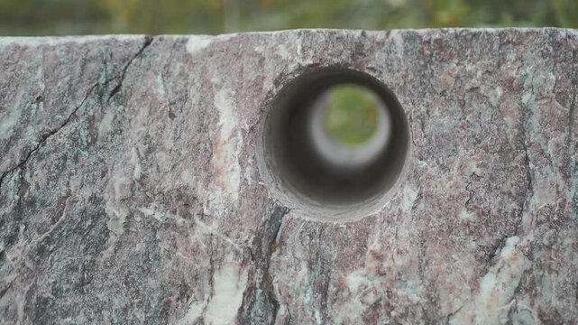 Petelinsky marble quarry. A technological hole about 100mm in diameter, drilled through an old marble block. Hand held. Siberia.