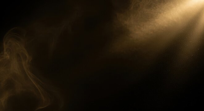 Golden light shining through smoke or dust particles on black background