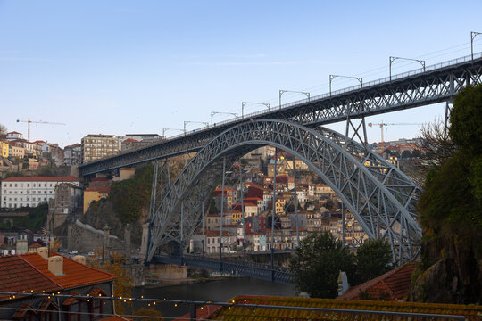 View of the Dom Luís I Bridge and the historic riverside district in Porto, Portugal. - Powered by Adobe