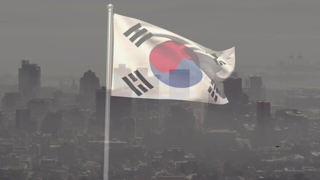 Gusts unfurling South Korean flag on pole, revealing taegeuk and trigrams against hazy skyline