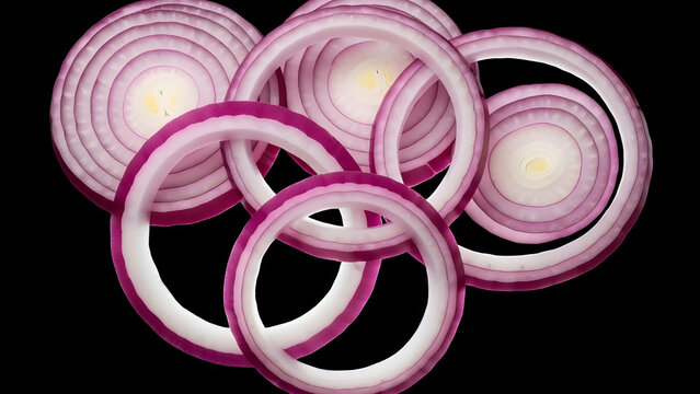 Five vibrant red onion rings with distinct concentric layers are artfully arranged against a stark black background for a dramatic culinary presentation