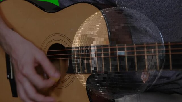 Right hand poised, plucking and strumming guitar strings, mirrored disc shifting, showing technique