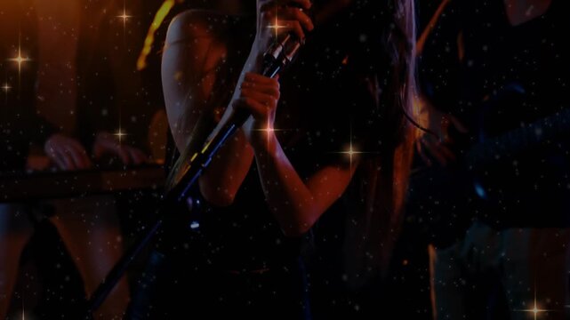 Lead female vocalist rising as camera tilts, with retro mic, singing music, band behind, sparkles - Powered by Adobe