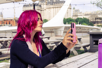 Woman taking selfie at puente de la mujer in buenos aires