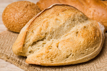 Homemade natural breads. Different kinds of fresh bread as background, perspective view with copy space