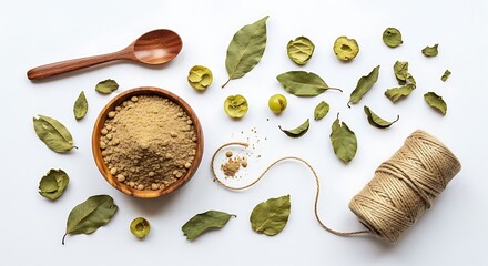 Top view of amla powder in bowl with dried leaf, seed, and twine roll isolated on white background