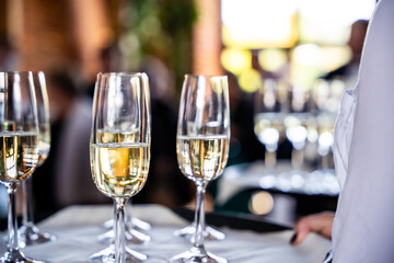 Champagne Glasses On Serving Tray During Festive Wedding Reception