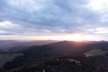 Fototapeta premium Serene Mountain Landscape At Sunset With Rolling Hills And Soft Evening Light