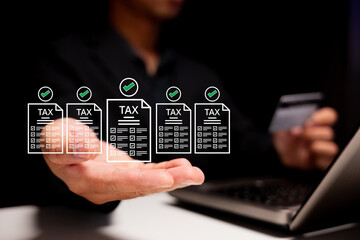 A person is managing tax documents digitally, with check marks indicating completion, while holding...
